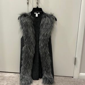 Sweater vest with fur trim.